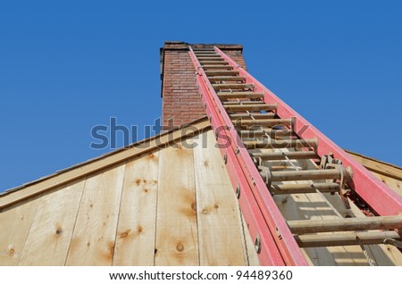 Ladder leaning against chimney to make masonry repairs