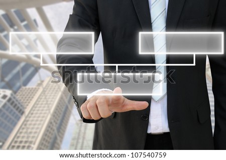 Businessman hand touch screen button of 2 choices blank chart with building background