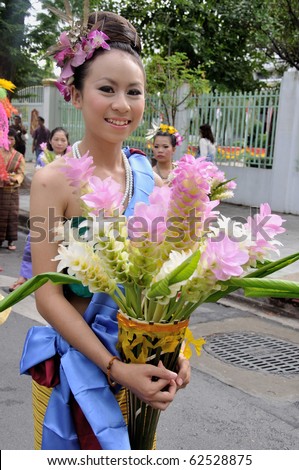 BANGKOK, THAILAND - OCTOBER 3: Thai lady in traditional dress in the parade of making traditional merit of people from the northern territory of Thailand, October 3, 2010 in Bangkok, Thailand.