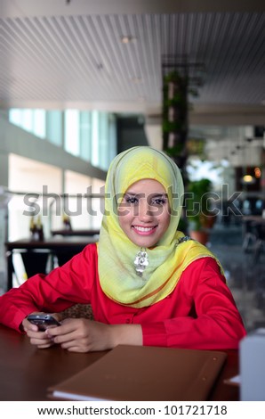young pretty Asian muslim business woman in head scarf waiting for interview