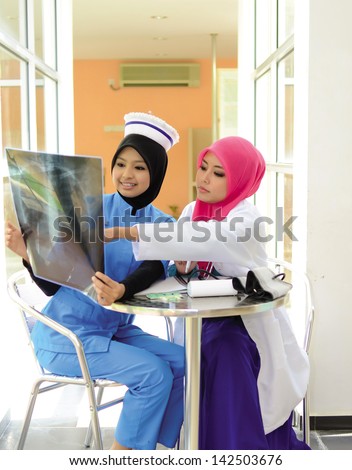 Confident Muslim doctor busy conversation at hospital