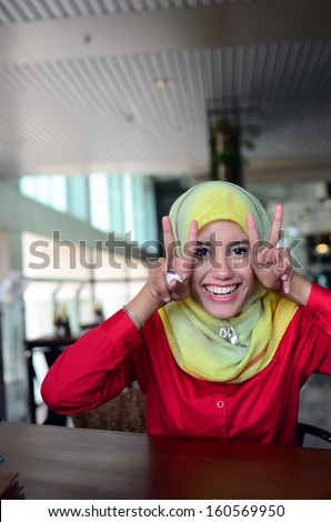 Beautiful young muslim college girl make funny face