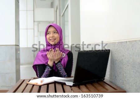 Portrait of muslim girl pray and smile