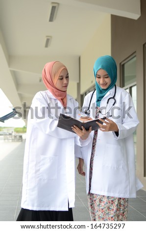 Confident Muslim doctor busy conversation at hospital