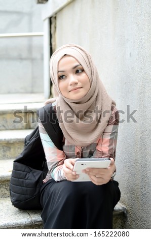 beautiful young muslim student sad while looking result at laptop