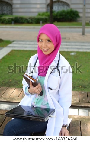 Confident Muslim doctor smile while rest at park
