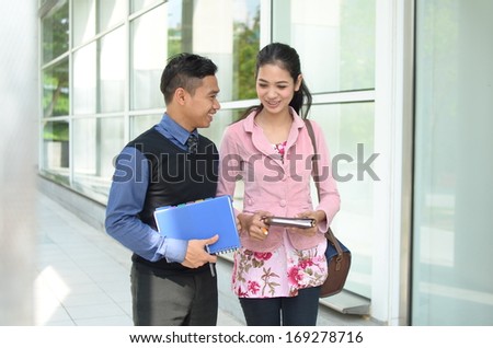 Close-up portrait of beautiful young Asian student walking together