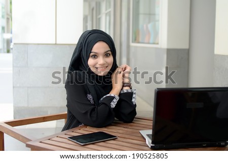 Young asian muslim woman in head scarf smile