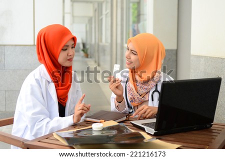 Confident Muslim medical student busy conversation at hospital