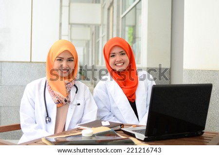Young asian medical student woman in head scarf smile