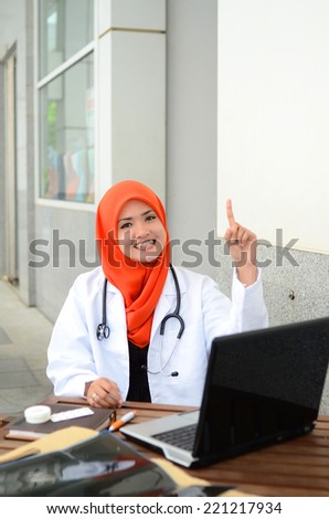 Confident Muslim medical student pointing finger