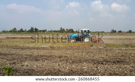 Kuala Selangor, Malaysia - Feb 15 , 2015: Tractor plowing a rice field at Kuala Selangor, Malaysia on February 15, 2015