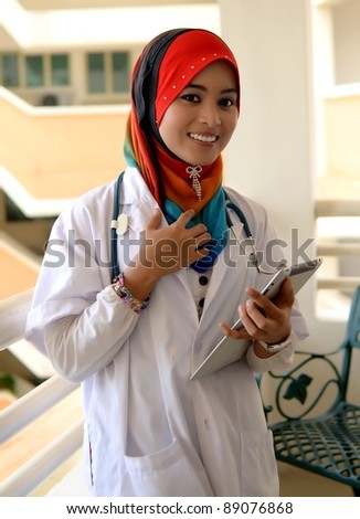 Portrait asian female Muslim doctor with tablet