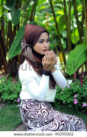 portrait of a beautiful young women Islamic Asia pray