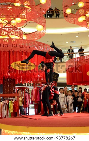 KUALA LUMPUR, MALAYSIA - JAN 16:Chinese Traditional Acrobatic girl performing during Chinese New Year on Jan. 16, 2012 in Kuala Lumpur, Malaysia. Mid Valley popular shopping destination in Malaysia
