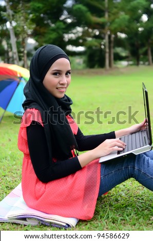 beautiful young muslim women college girl with laptop.