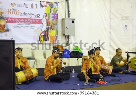 KUALA LUMPUR, MALAYSIA - MARCH 30: Performing music martial arts skills during the exhibition at the National Craft Day 2012 at the Kuala Lumpur Craft Complex on March 30, 2012 in Kuala Lumpur