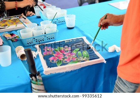 PUTRAJAYA, MALAYSIA-FEBRUARY 26: An unidentified student participates in a coloring batik contest with design by Kraf Selangor during WOW Putrajaya Carnival on February 26,2012 in Putrajaya Malaysia.