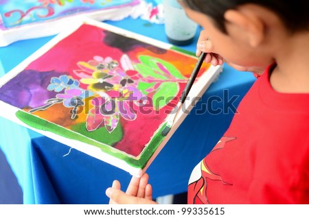 PUTRAJAYA, MALAYSIA-FEBRUARY 26: An unidentified student participates in a coloring batik contest with design by Kraf Selangor during WOW Putrajaya Carnival on February 26,2012 in Putrajaya Malaysia.