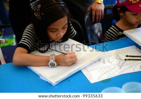PUTRAJAYA, MALAYSIA-FEBRUARY 26: An unidentified student participates in sketches for batik contest with design by Kraf Selangor during WOW Putrajaya Carnival on February 26,2012 in Putrajaya