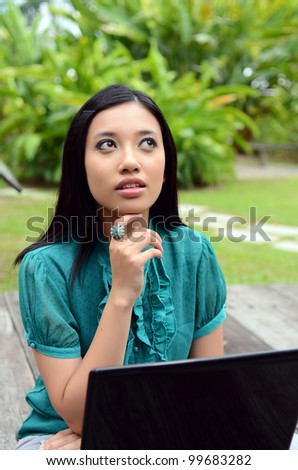 young pretty girl businesswoman using laptop in nature