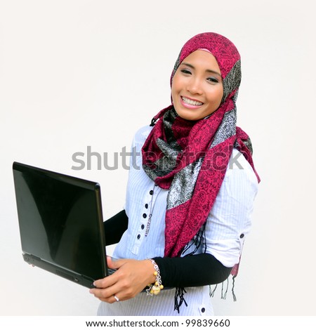 Beautiful young muslim woman happy with laptop isolated white background
