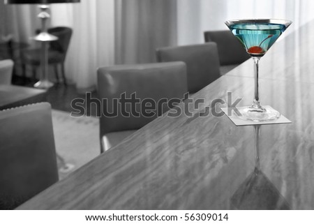 Blue martini with a red cherry
