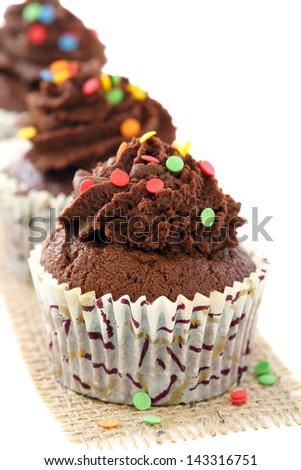 Chocolate cupcakes on a white background close up.