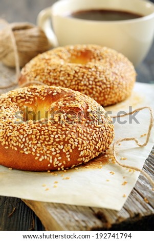 Bagels with sesame and coffee on the old table.