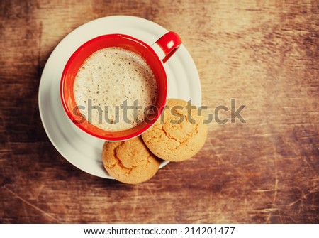 Coffee and biscuits on wooden board