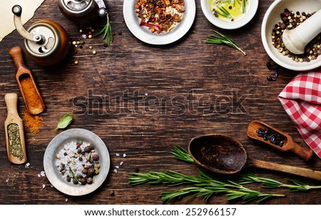 Spices for use as cooking ingredients on a wooden background, with copyspace