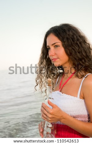 beautiful woman with letter in bottle have a dreams