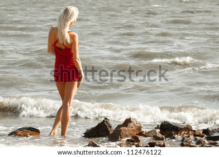 Alone woman at the sea on a sunny day