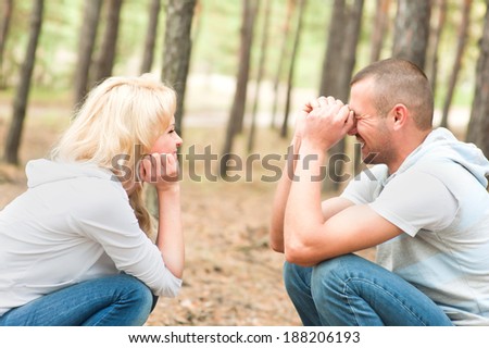 Attractive couple in the woods laughing and feeling good with each other