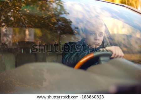 Handsome guy in the car looks at the road