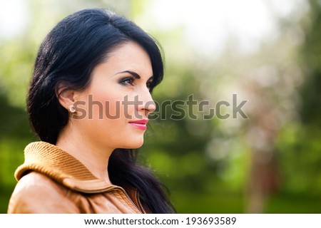 woman looking into the distance in the park