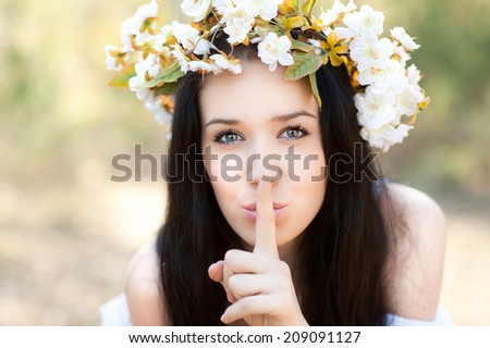 Woman in the forest with flowers shushing