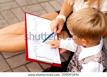 child businessman studying blueprints on the planchette