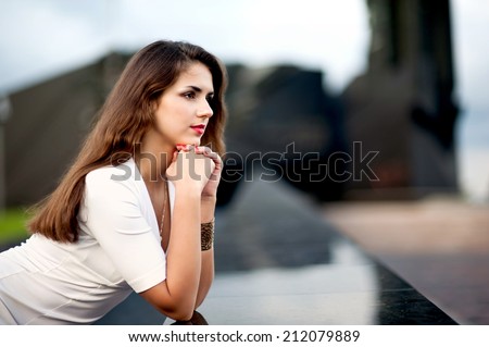 woman in the park looks into the distance