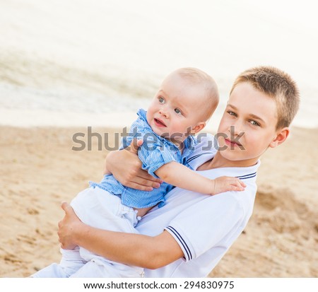 The teenager holding a child and feels the joy and unity