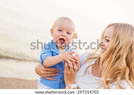 A woman holding a child and feels the joy and unity