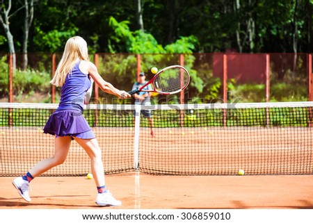 Woman playing tennis and preparing for sports competition. Professional athlete in a form proves the equality of women over men.