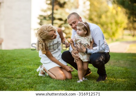 Beautiful family together.A man dressed in a business-like style, using his free time to spend time with his lovely daughter.
