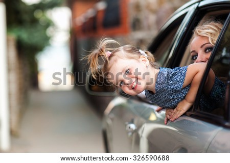 Man woman and child near the car are going on a trip