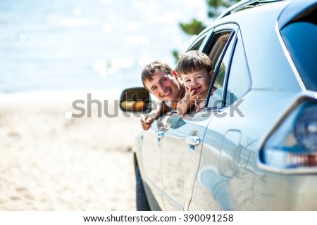 Portrait happy, smiling Family, father, one kid sitting in the white, silver car looking out windows, ready for vacation trip, outdoor background. Positive Human face expression, emotions, feelings