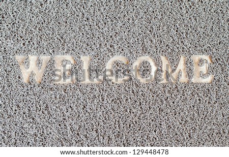 Dirty welcome doormat  placed near the entrance.