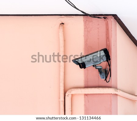 Small CCTV on the wall of school building.