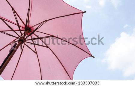 Red wooden umbrella of small coffee shop in the summer time.