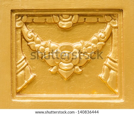 Golden statue frame on the wall of Thai temple.