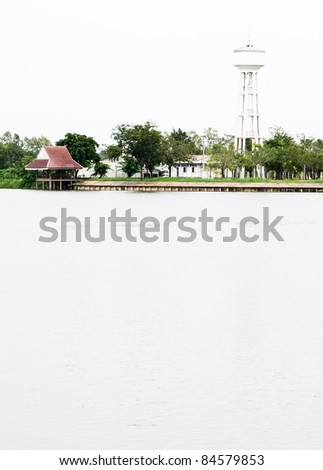 White tower to store water for water supply located along the lake.